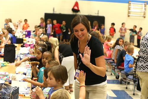 Gates lunch room and student high-fiving teacher