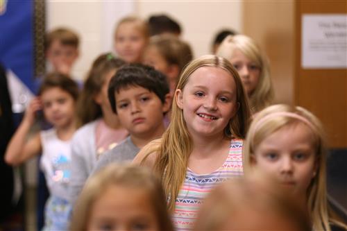 Engleman Elementary students smiling and standing in line