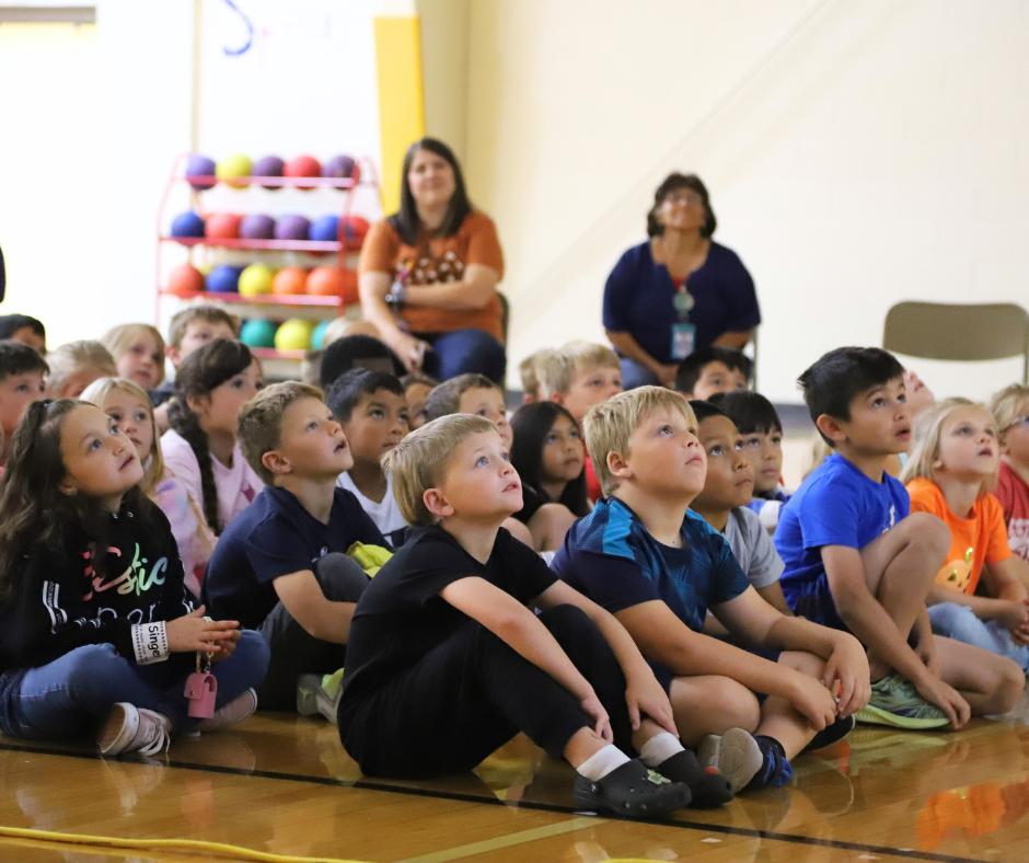 Engleman Elementary 2nd Graders listening to Alan Katz in the gym.
