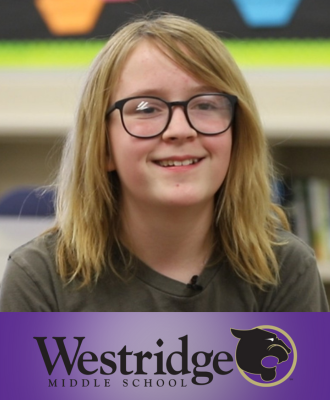  Smiling 8th Grade student, Brooke, in a classroom with the Westridge logo.