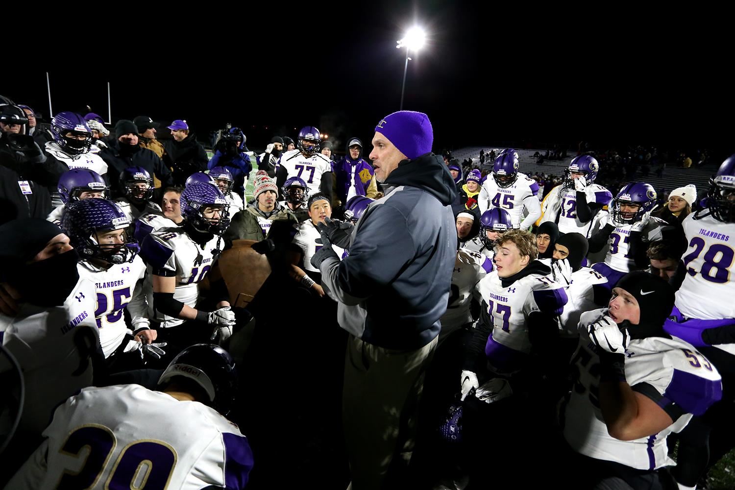 Coach Tomlin speaking to kneeling GISH Football team after a state football playoff game