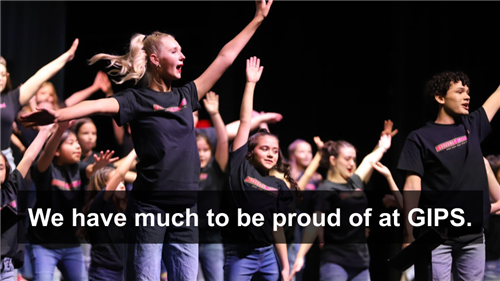 Photo of high school show choir singing and dancing with elementary kids on stage - "We have much to be proud of at GIPS"of