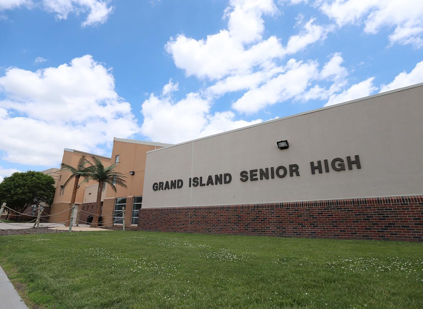 Outdoor facade of Grand Island Senior High main entry way with palm trees