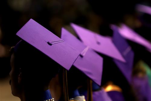 Silhouettes of GISH students wearing graduation regalia