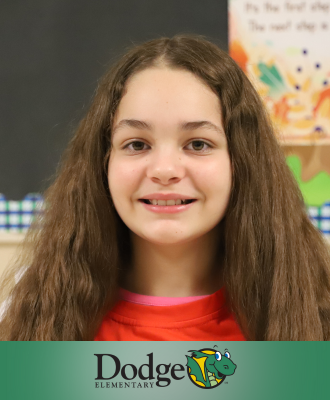  Jany, Dodge 5th Grader, smiling in a school hallway. 