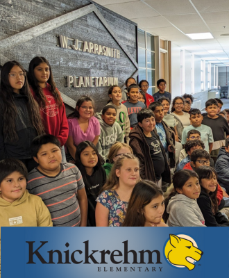  Smiling group of Knickrehm 5th Graders sitting in front of the GISH Planetarium sign.