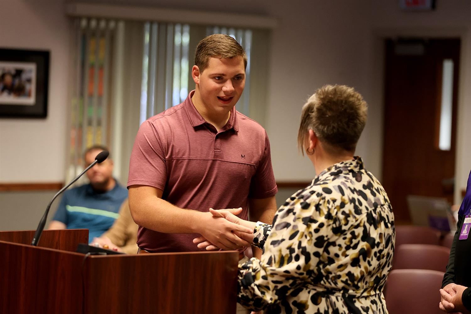 Owen Williams shaking hands with GIPS Associate Superintendent, Dr. Summer Stephens, after swearing in.