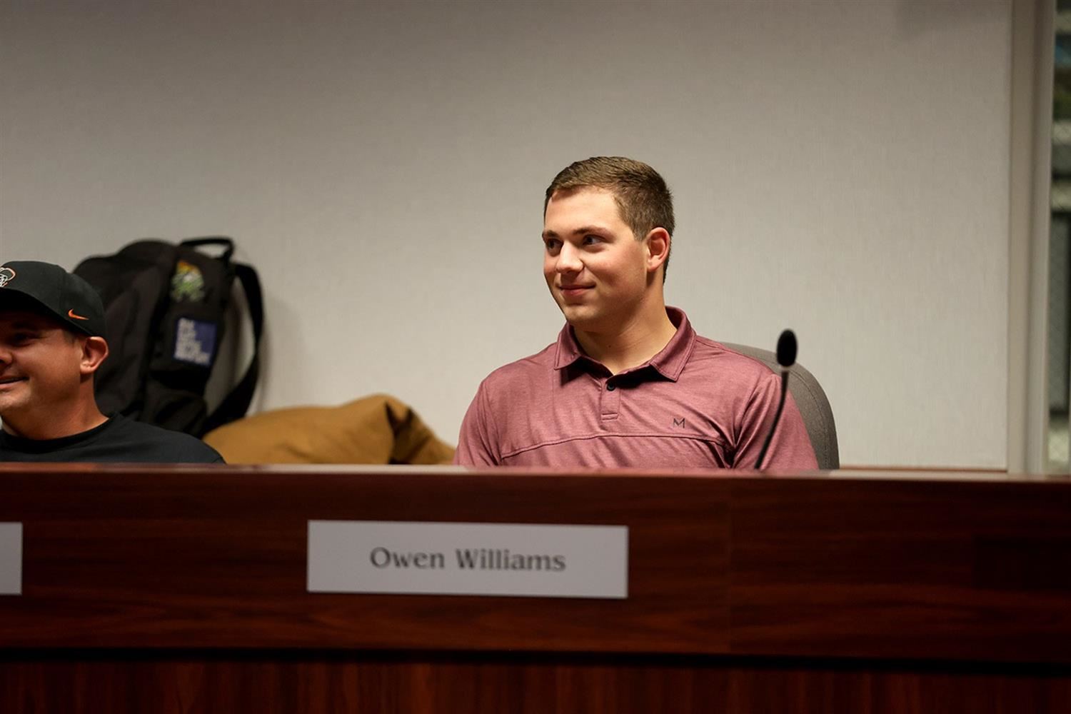 Owen Williams sitting at his seat at the GIPS Board of Education rotunda.
