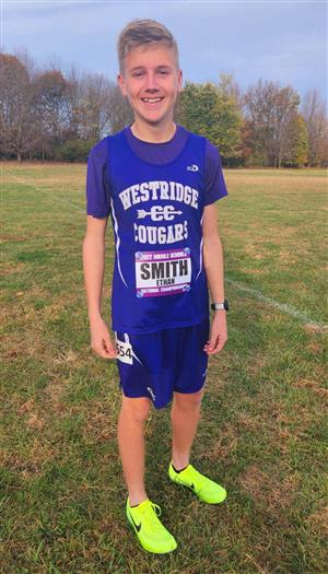 Middle School cross country runner posing in race uniform.