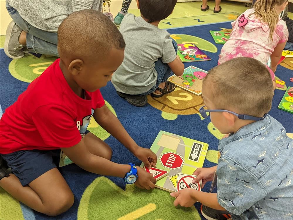 Students sharing a puzzle at OLC