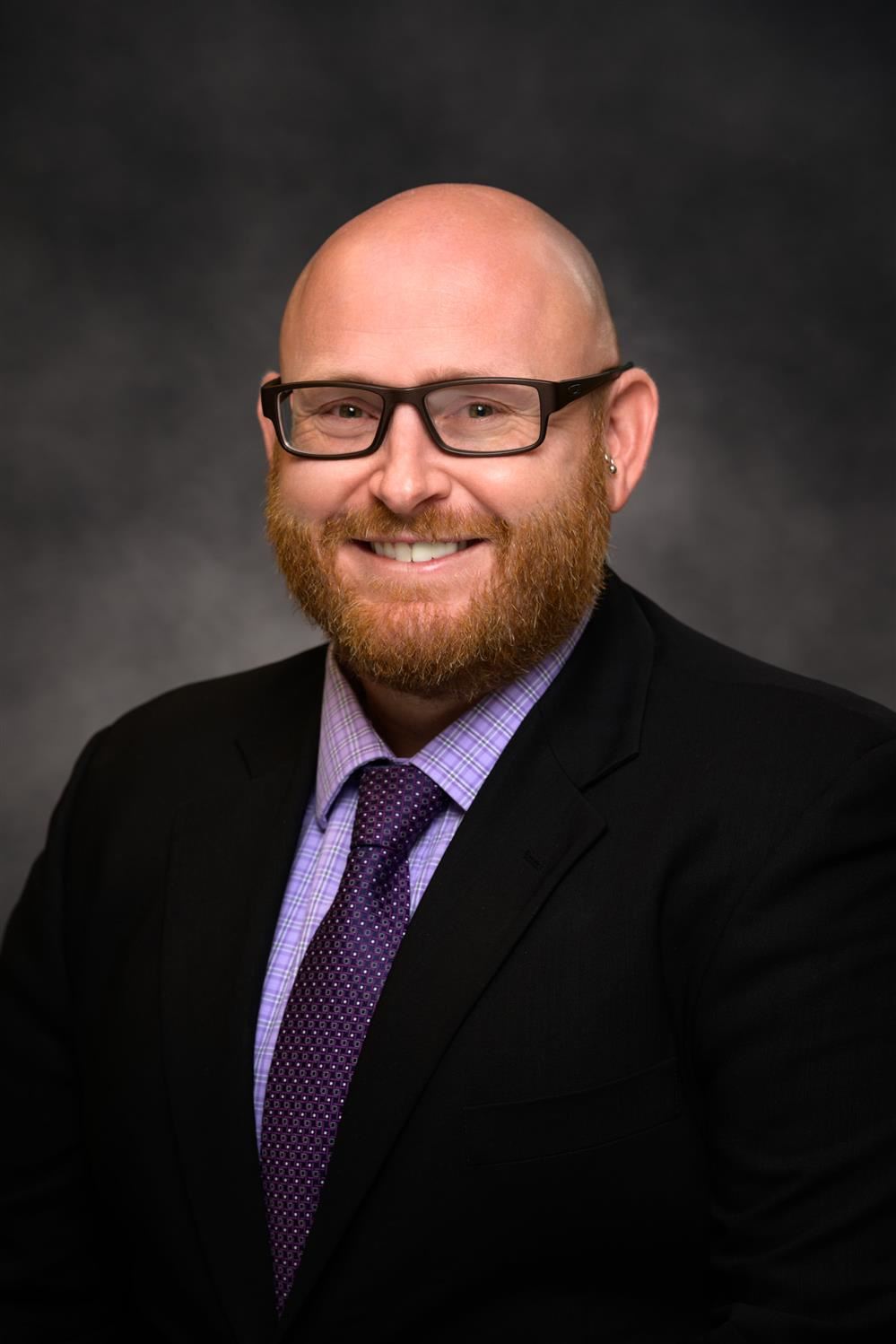 Nate Helzer headshot Nate Helzer headshot